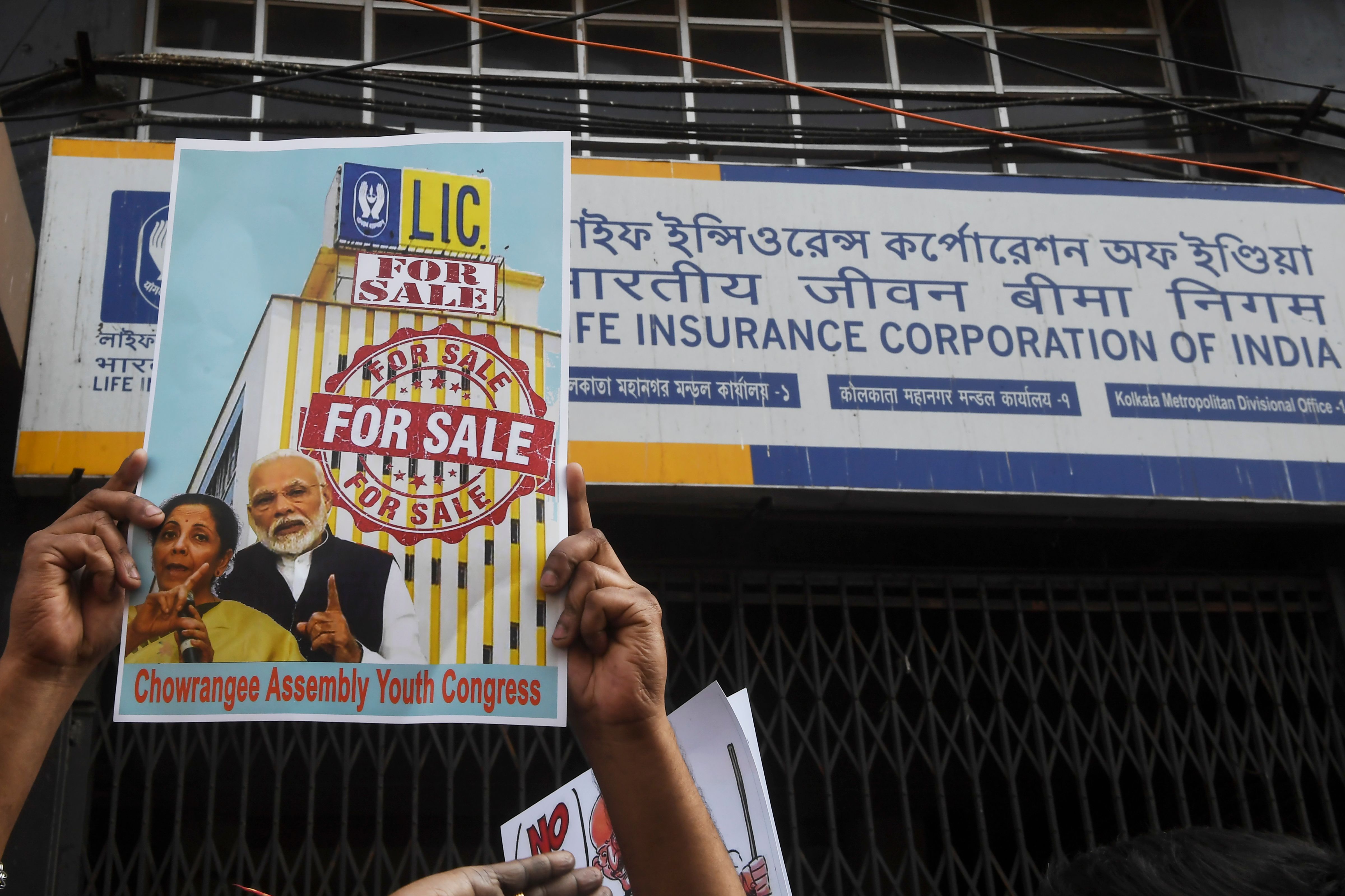 An activist&nbsp;holds a placard&nbsp;in front of a Life Insurance Corp.&nbsp;office in Kolkata on Feb.&nbsp;3.