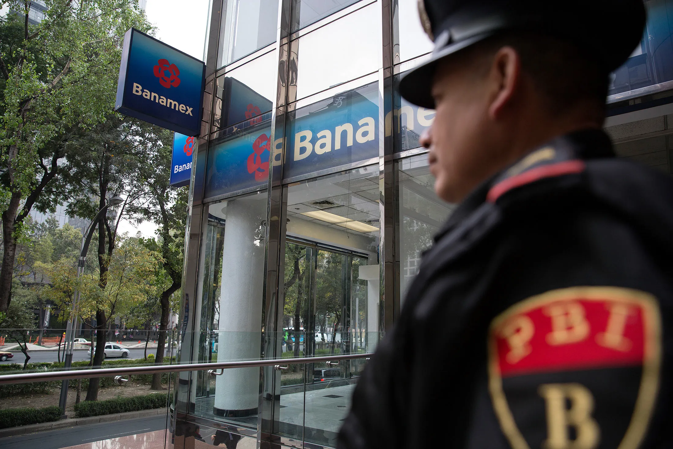 A Banking and Industrial police stands outside guarding one of the Banamex Bank branches at the Avenue Reforma in Mexico City, Mexico, on Nov. 13, 2014.
