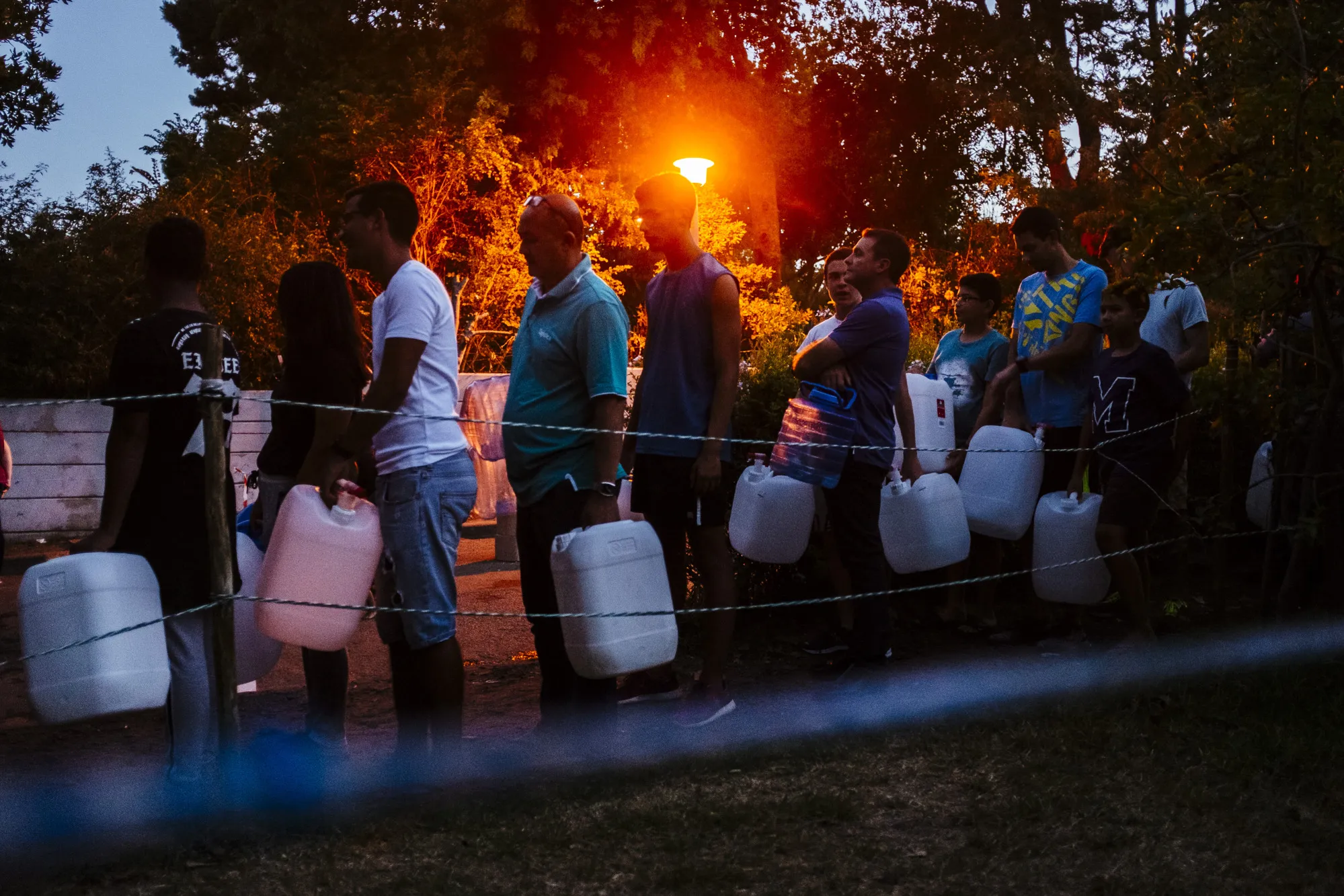 Residents queue to fill plastic water&nbsp;containers&nbsp;at a&nbsp;natural&nbsp;spring in Cape Town in 2018.