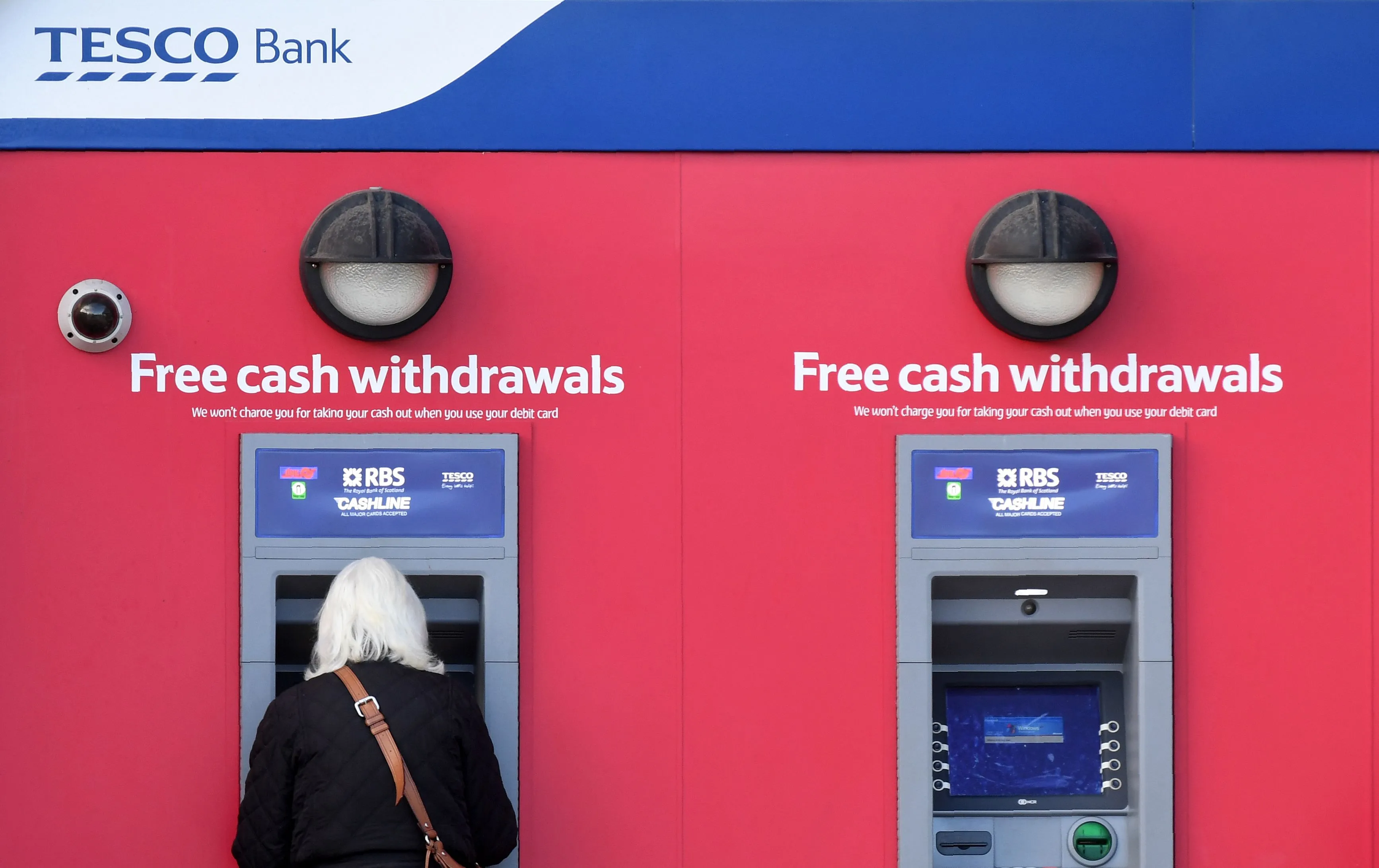 A customer uses an ATM at a Tesco Bank cash point&nbsp;in Liverpool.