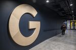 A worker walks past a logo inside Google's new Bay View campus in Mountain View, California.