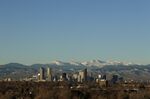 The Rocky Mountains rise behind the Denver skyline.