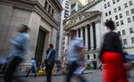 Pedestrians walk along Wall Street near the New York Stock Exchange (NYSE) in New York, U.S., on Monday, Aug. 14, 2017. U.S. stock-index futures advanced and volatility subsided as an escalation of tensions between the U.S. and North Korea showed signs of easing after American officials talked down the possibility of an imminent nuclear war.