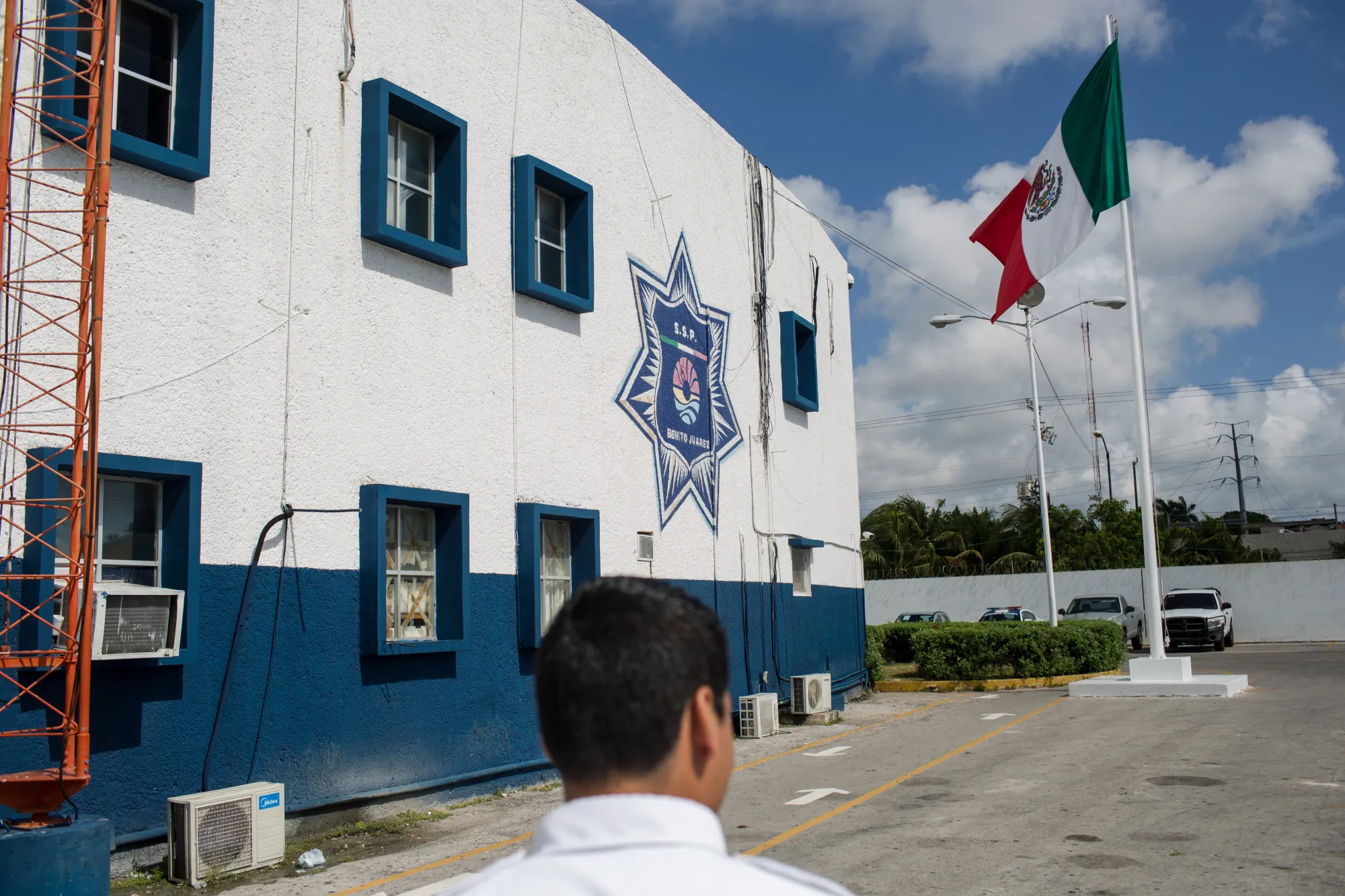 A Mexican flag flies outside a police station in Cancun.