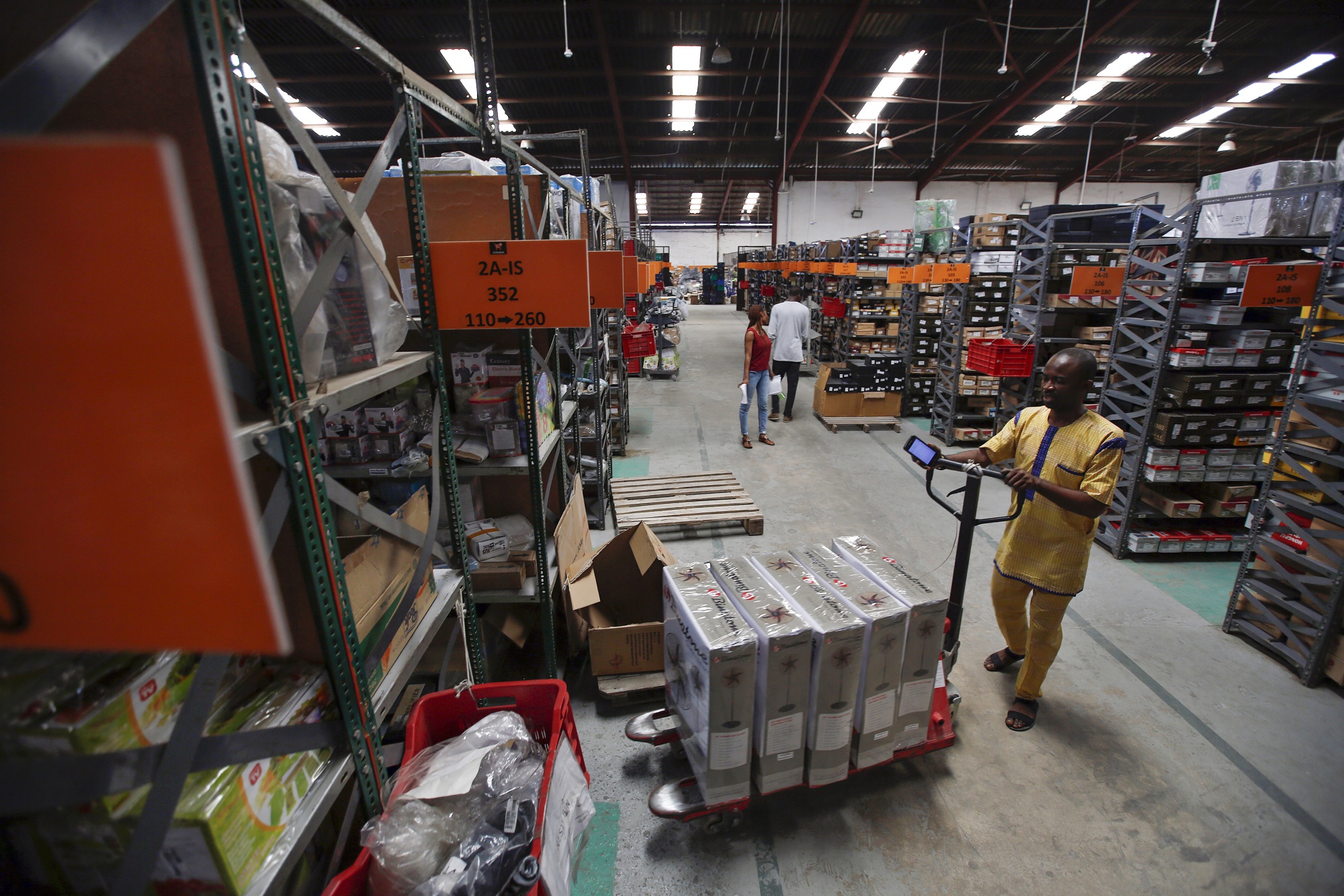 A worker pushes a pallet truck of stock inside a Jumia Technologies AG distribution warehouse in Lagos, Nigeria.