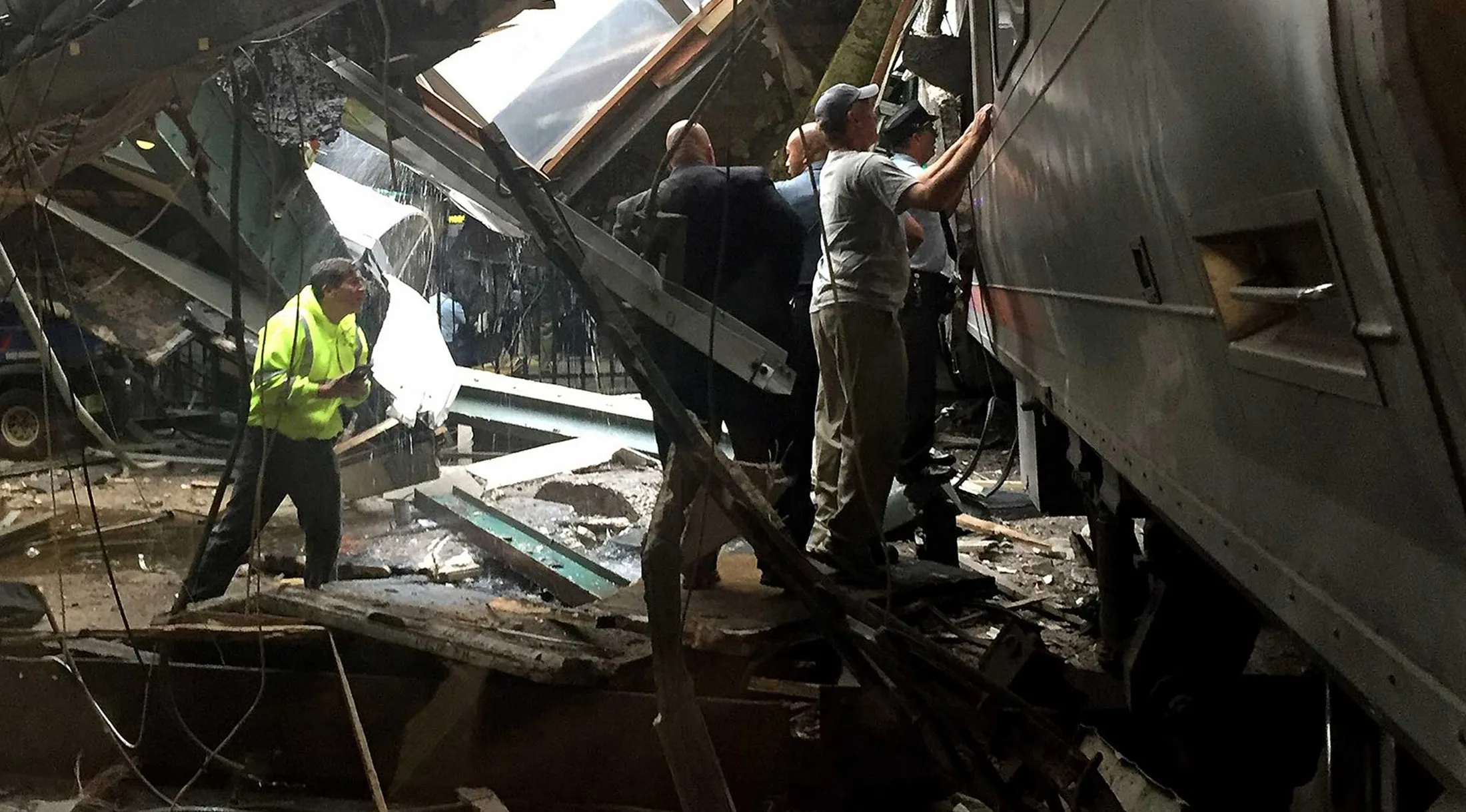 Train personel survey the NJ Transit train that crashed in to the platform at the Hoboken Terminal Sept.&nbsp;29, 2016.