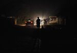 People walk in darkness in Chitungwiza.