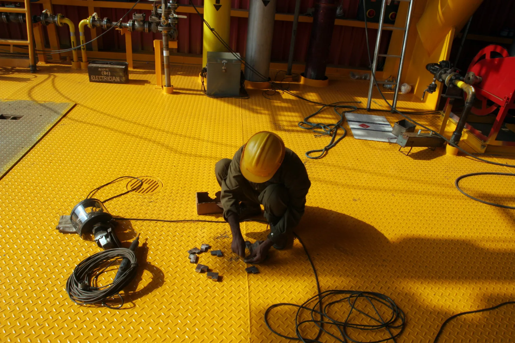 A Larsen &amp; Toubro Ltd. employee works on a booster compressor process module, part of an offshore oil drilling platform, in Hajira, India.
