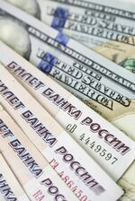 Russian Ruble notes sit on top of a pile of American Dollar bills in this arranged photograph in London, U.K., on Monday, Aug. 24, 2015.