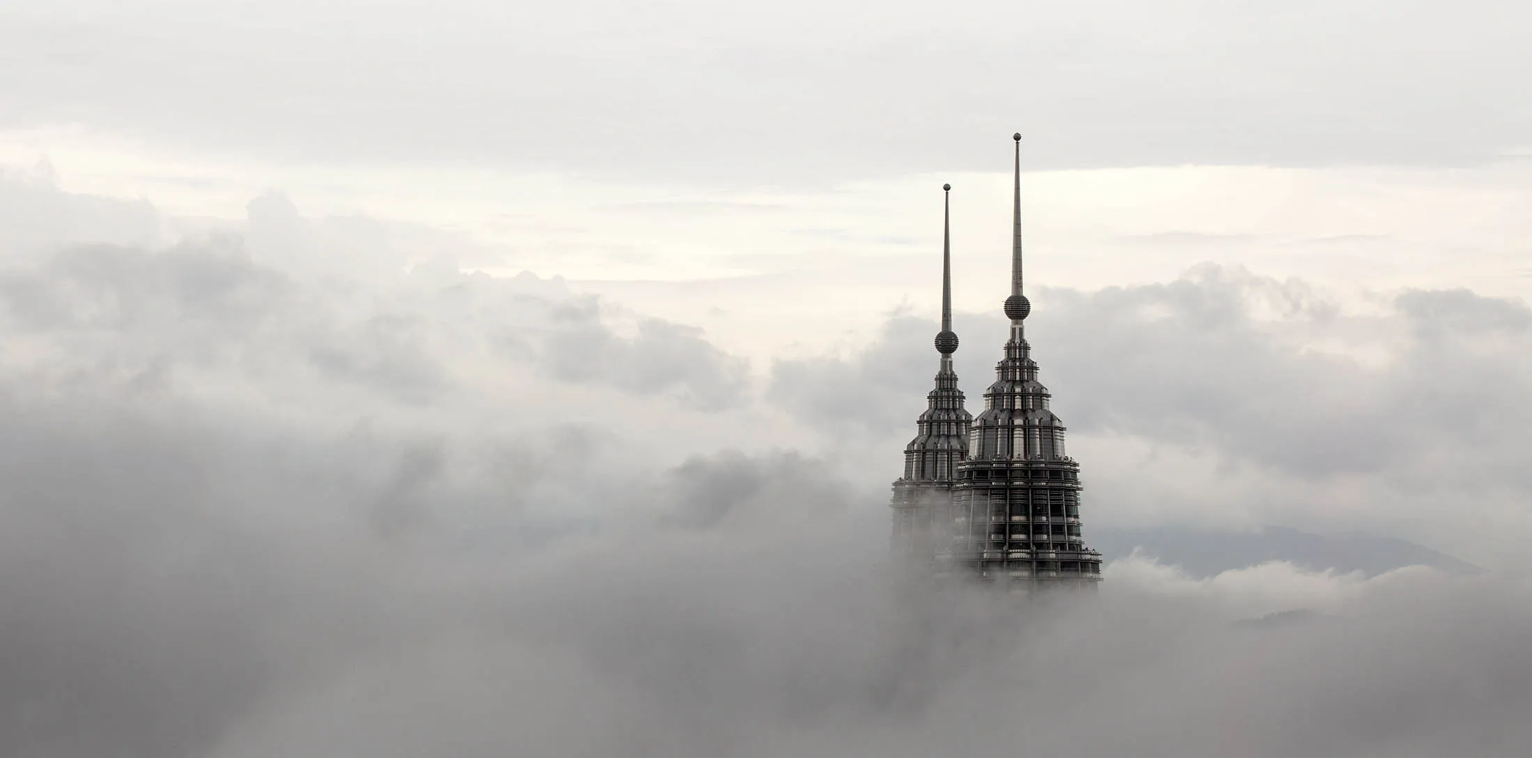 Bloomberg's Best Photos 2014: The pinnacles of the Petronas Twin Towers protrude through low clouds in Kuala Lumpur, Malaysia, on Tuesday, March 18, 2014. Malaysia, aspiring to become a developed nation in six years, is finding that more than 50 years under one coalition and tight control over information is a mismatch for handling a rapidly growing crisis followed across the world.
