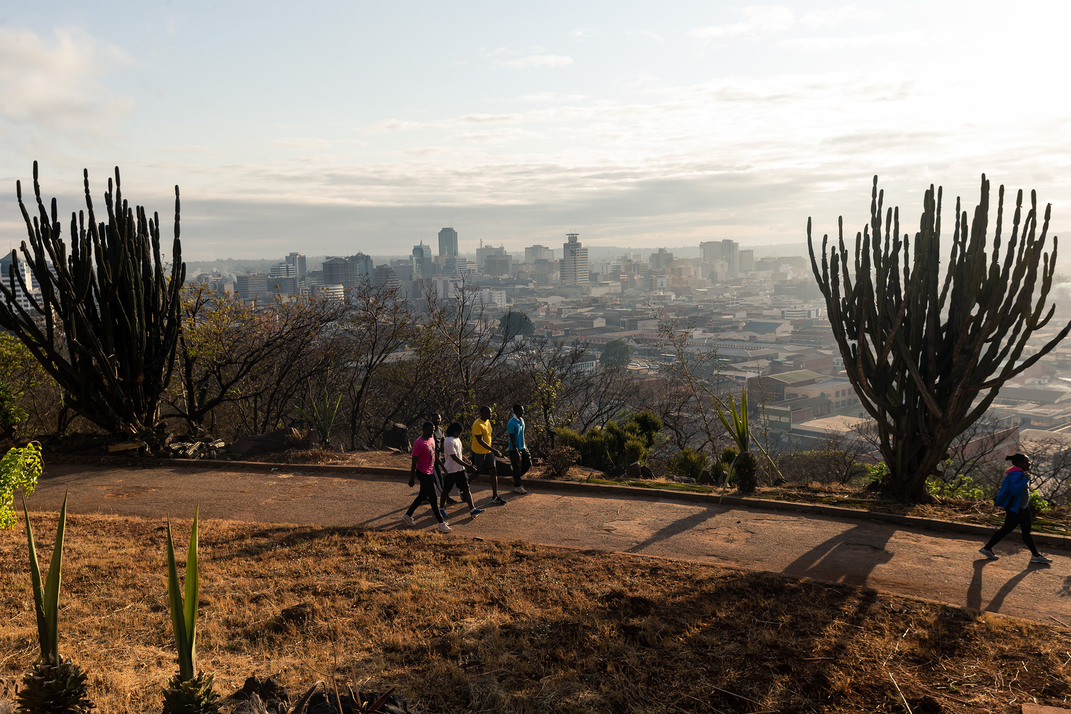 People walk&nbsp;on Kopje&nbsp;overlooking the city of Harare,&nbsp;Zimbabwe.&nbsp;