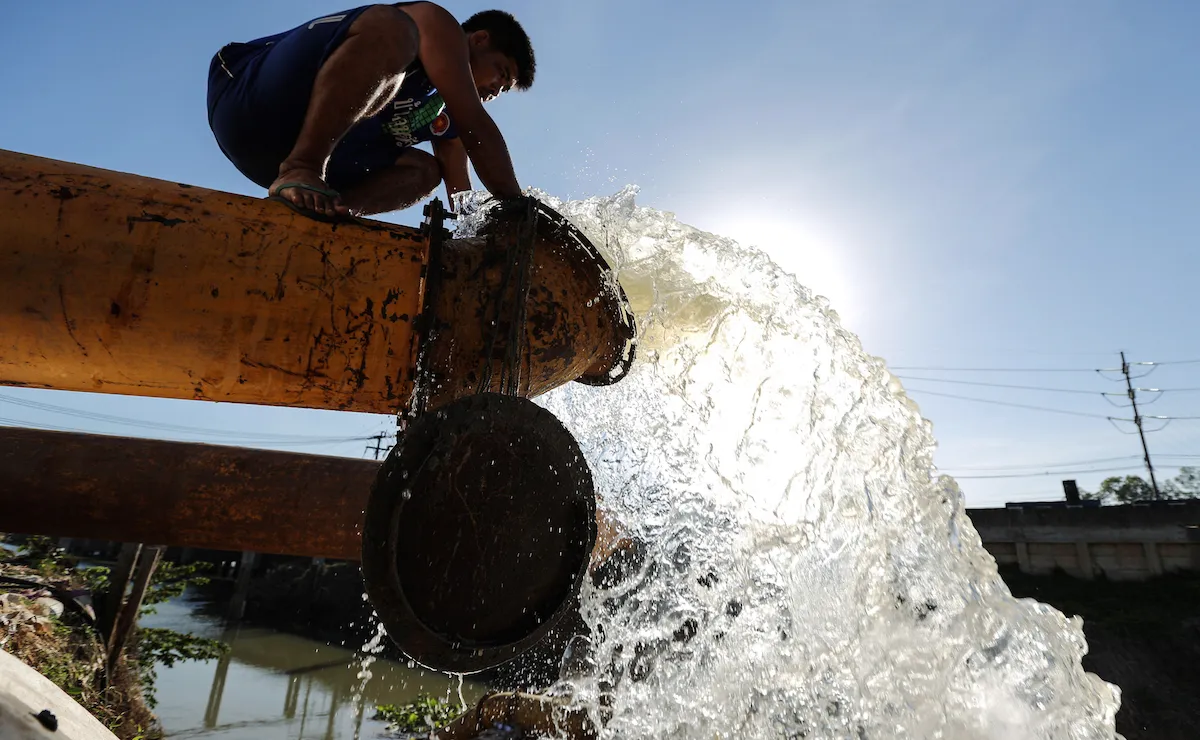 A worker opens a water pipe at an irrigation canal in Chainat, Thailand. Thailand's key reservoirs have fallen to the lowest since 1987, and farmers have been warned to delay planting their rice.
