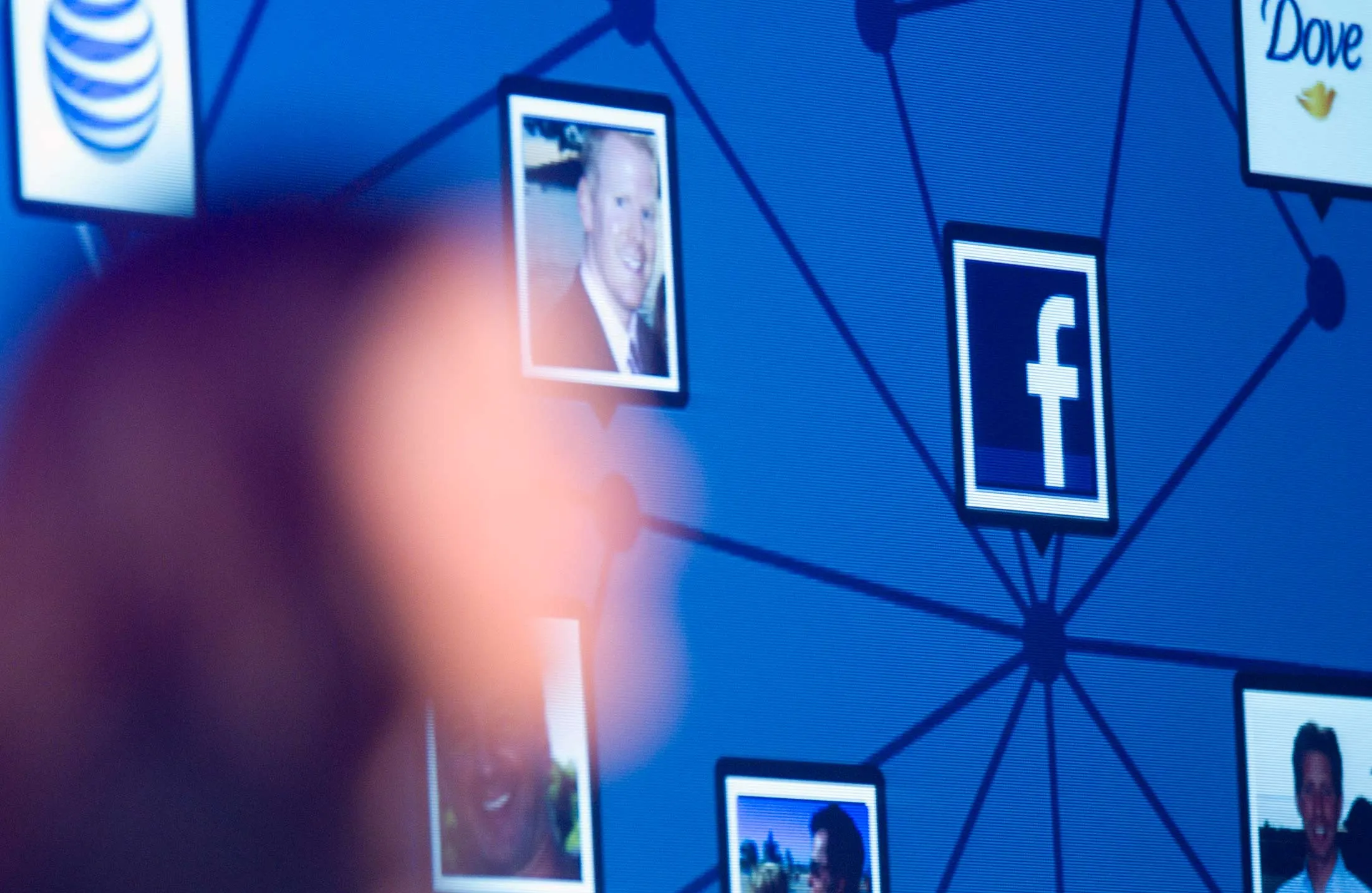 The Facebook logo is displayed as Chief Operating Officer Sheryl Sandberg speaks at an advertising conference in New York on Sept. 28, 2010.
