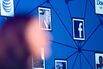 The Facebook logo is displayed as Chief Operating Officer Sheryl Sandberg speaks at an advertising conference in New York on Sept. 28, 2010.
