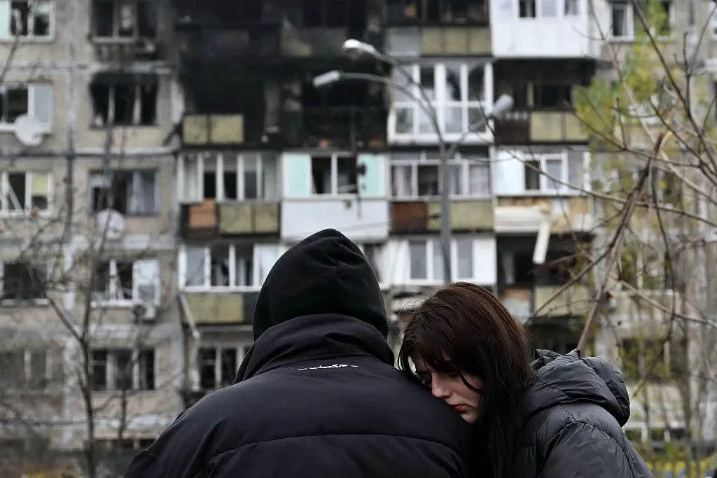 Local residents react in front of a damaged residential building following an air&nbsp;attack in Kyiv, on Nov.&nbsp;29.