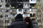 TOPSHOT - Local residents react in front of a damaged residential building following an air attack in Kyiv on November 29, 2025, amid the Russian invasion in Ukraine. A Russian drone attack targeted the Ukrainian capital in the early hours of November 29, 2025, killing one person and wounding seven, authorities in Kyiv said. (Photo by Genya SAVILOV / AFP via Getty Images)