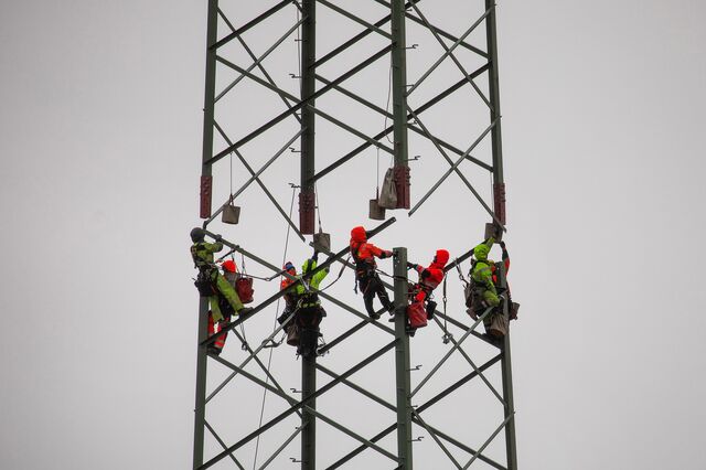 Workers assemble a high voltage electricity transmission tower in Klockow, Germany.
