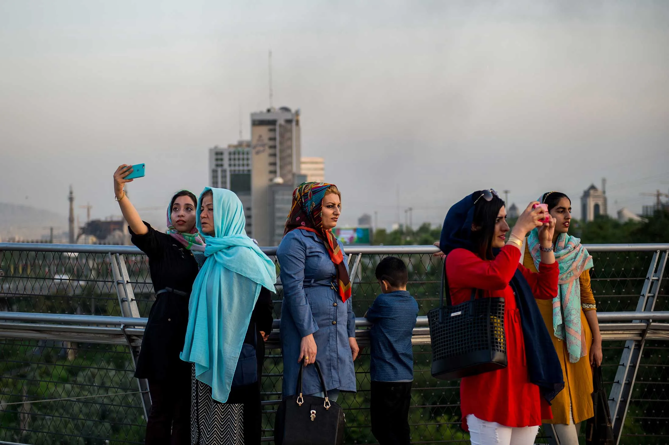 Pedestrians pause to take photos along the Tabiat Bridge in Tehran on Aug. 4.