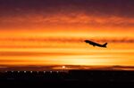 An aircraft takes off at sunrise.