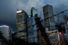 A barbed-wire fence stands near buildings illuminated at dusk in the Central district in Hong Kong, China, on Monday, June 22, 2020. The U.S. Senate approved a bipartisan measure on June 25 that would penalize banks doing business with Chinese officials involved in the national security law the country is seeking to impose on Hong Kong.