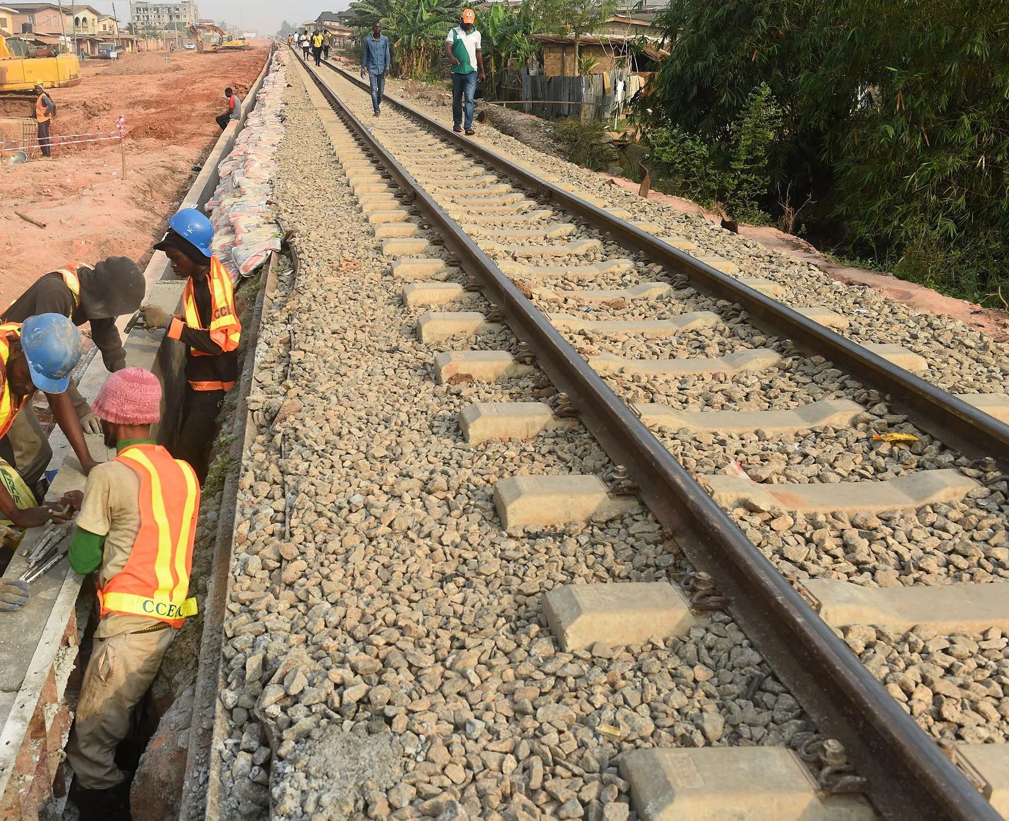 Workers lay slab at the new standard gauge railway line under construction from Iju in Lagos to Abeokuta, Ogun State in southwest Nigeria, on February 7, 2019.
