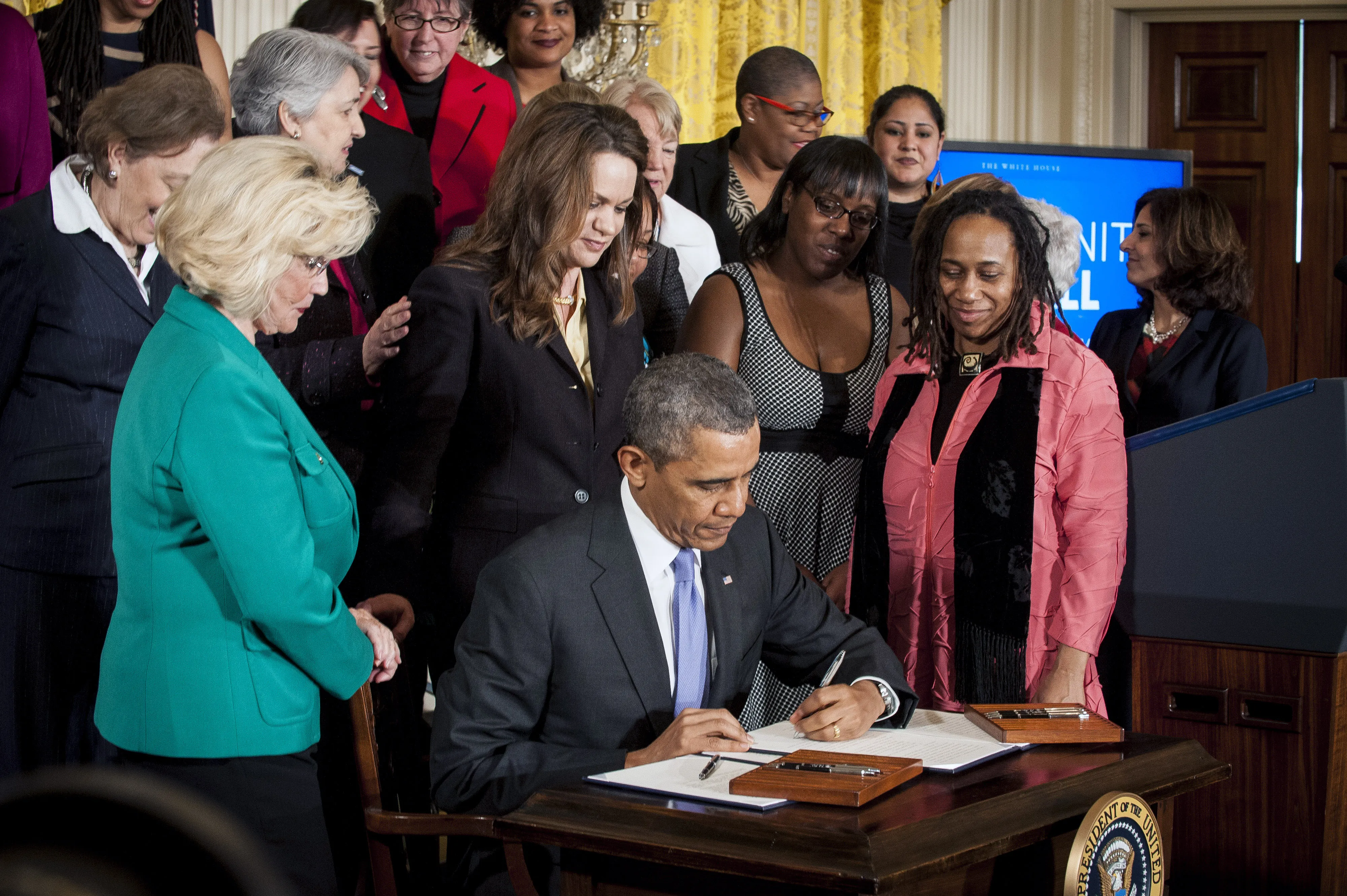 President Barack Obama signs an Executive Order and a Presidential Memorandum at an event marking Equal Pay Day in the East Room of the White House in Washington, D.C., U.S., on Tuesday, April 8, 2014.
