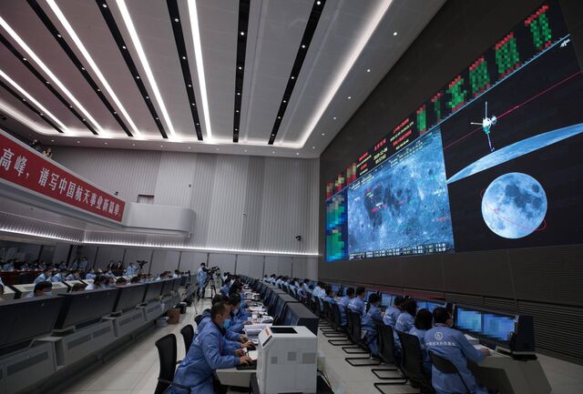 During the Chang’e-5 mission in December 2020, Chinese space agency personnel monitor the transfer of moon samples from one uncrewed craft to another in preparation for sending them to Earth.