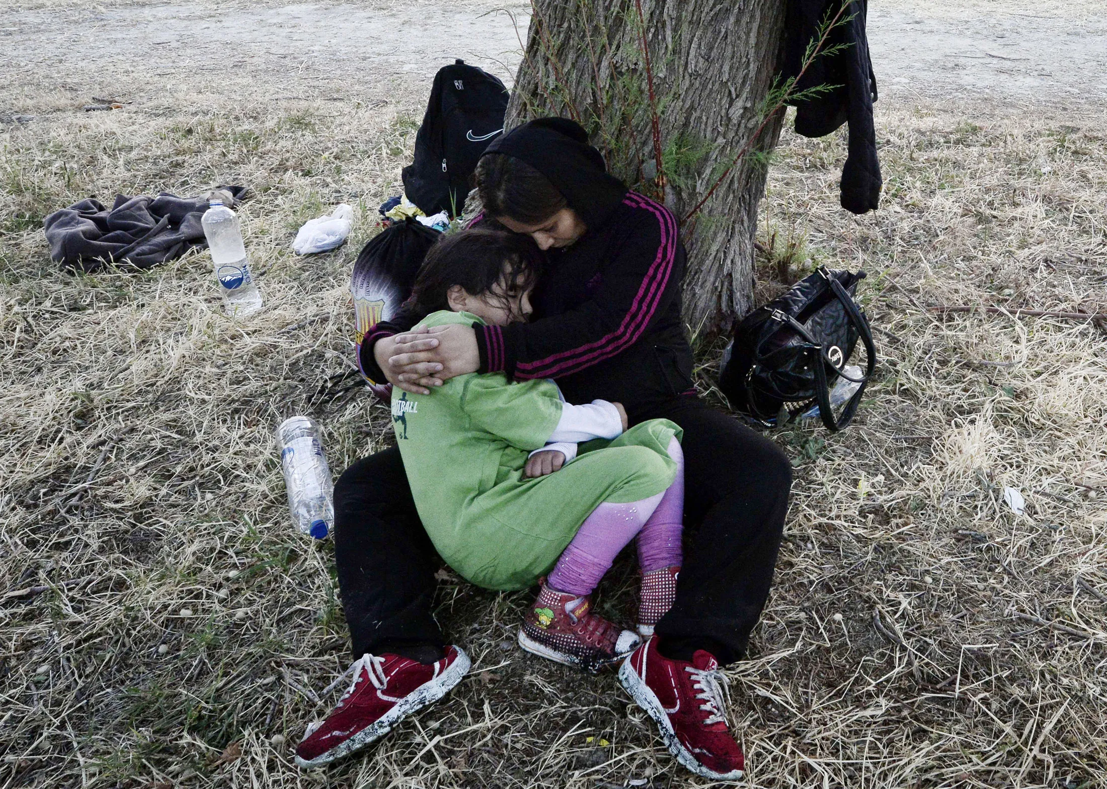 A Syrian mother holds her daughter after arriving on the Greek Island of Lesbos.
