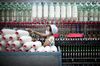 A worker manufactures cotton yarn at a factory in Dali county, Shaanxi province, China, on Wednesday, April 27, 2011. China,