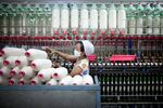 A worker manufactures cotton yarn at a factory in Dali county, Shaanxi province, China, on Wednesday, April 27, 2011. China,