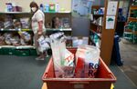 A volunteer prepares bags for distribution at a food bank in Harold Hill, UK.