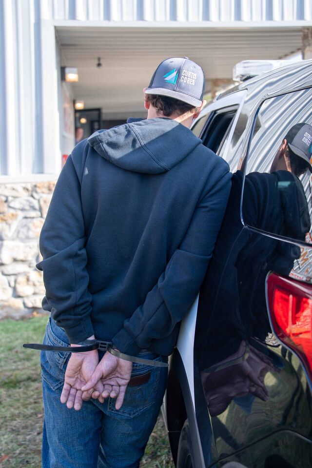 A suspect under arrest following the Oklahoma raid