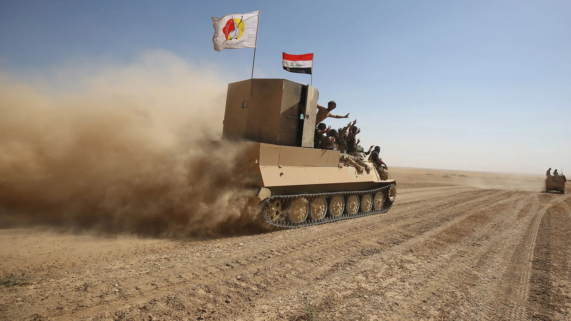 Fighters from the Hashed al-Shaabi (Popular Mobilisation) paramilitaries advance towards the city of Tal Afar.
