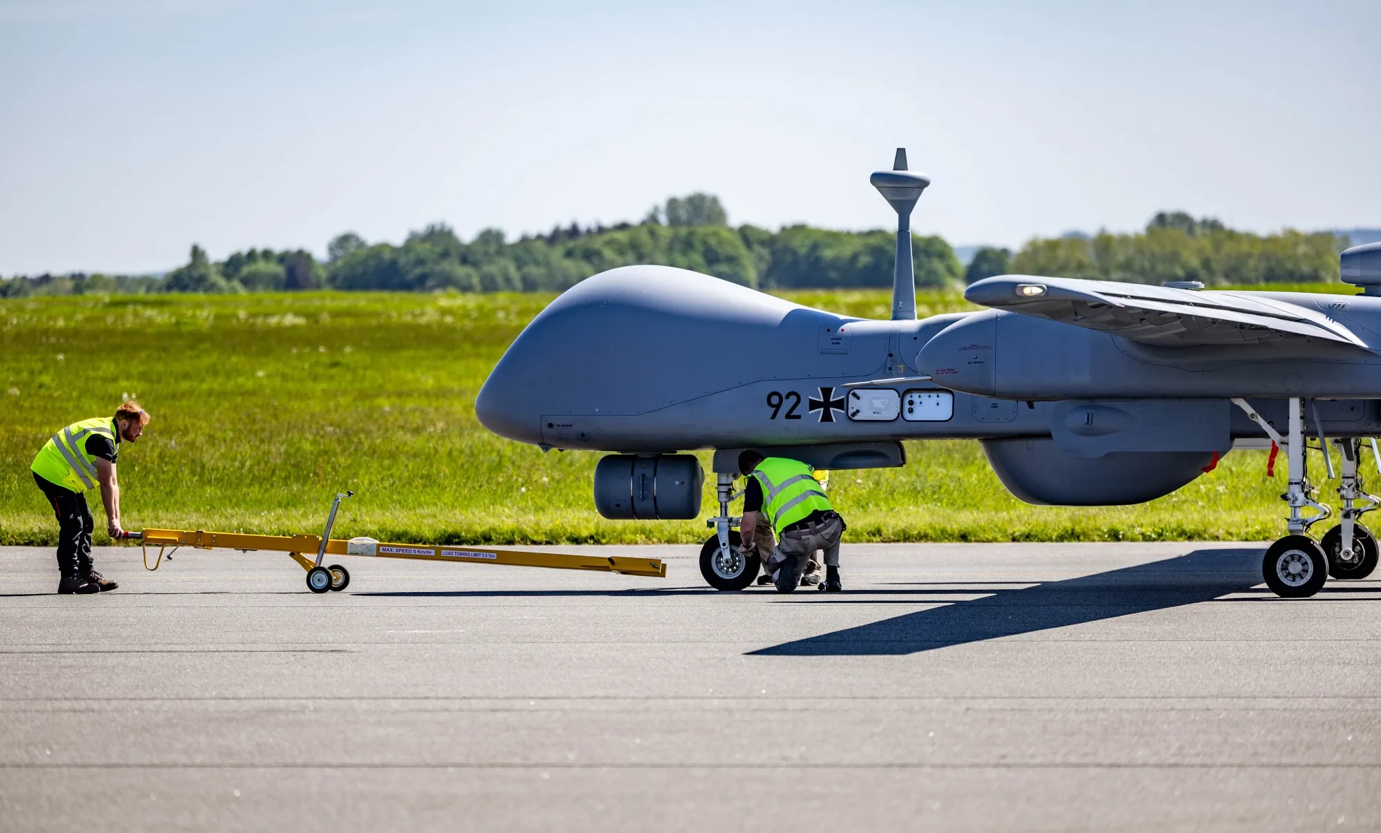 Technicians inspect a German Heron TP drone after its first official flight over northern Germany in 2024.