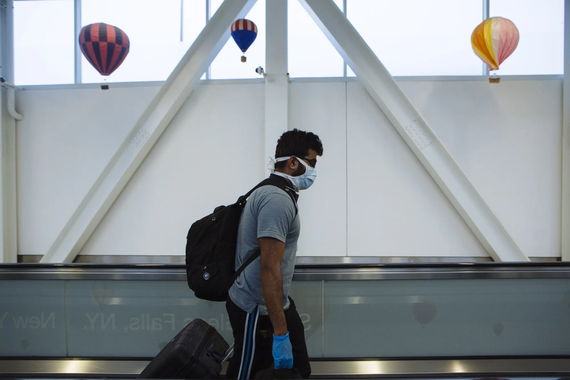 A traveler walks on a moving walkway at John F. Kennedy International Airport in New York on April 9.