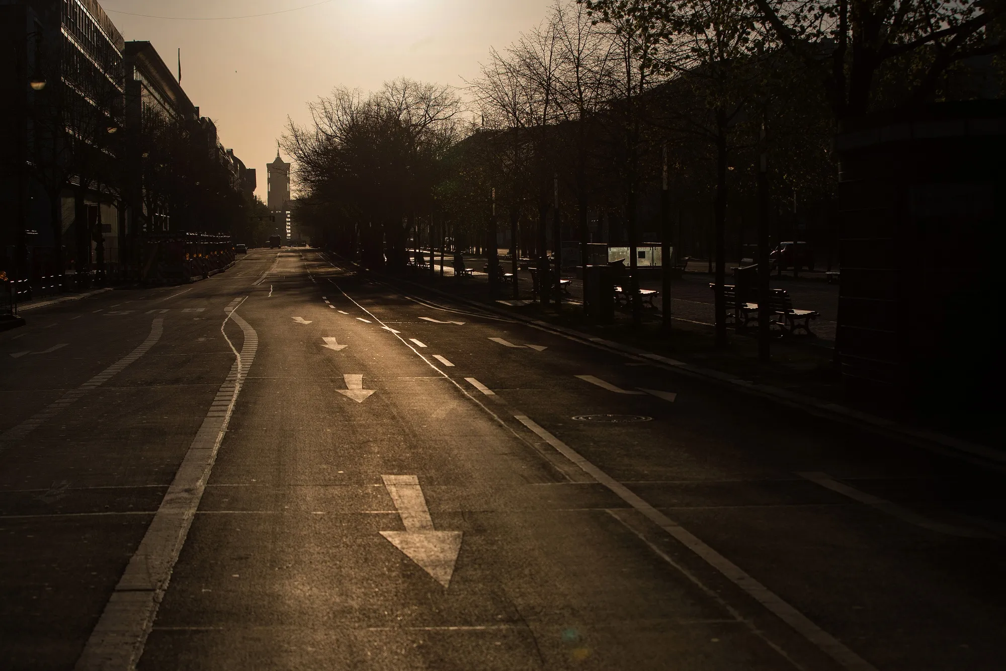Road markings sit on an empty Unter den Linden boulevard at dawn in Berlin on April 11