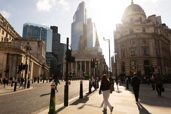Commuters pass the Bank of England in the City of London
