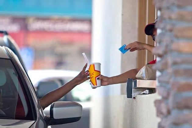 Service at a drive-through restaurant window in San Diego