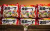 Packets of Nissin Food instant noodles sit on a shelf at a store in Hong Kong.