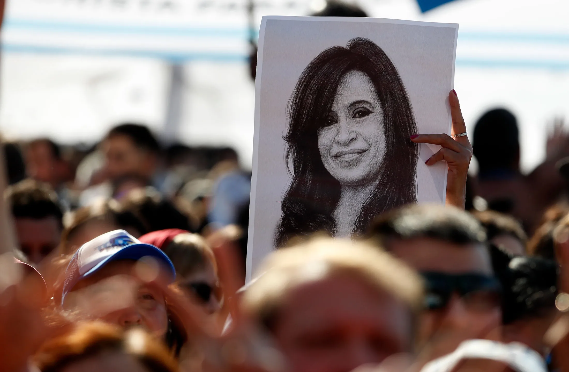 A man holds a drawing of former President Cristina Fernández at a September&nbsp;event in Buenos Aires marking the publication of her memoirs.&nbsp;