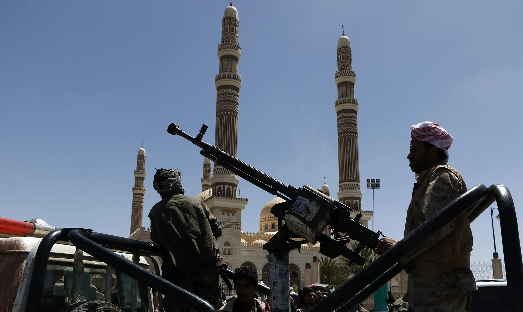 Houthi fighters stand guard during a ceremony held for collecting supplies for their fighters in Sana'a, Yemen on Sept. 22.
