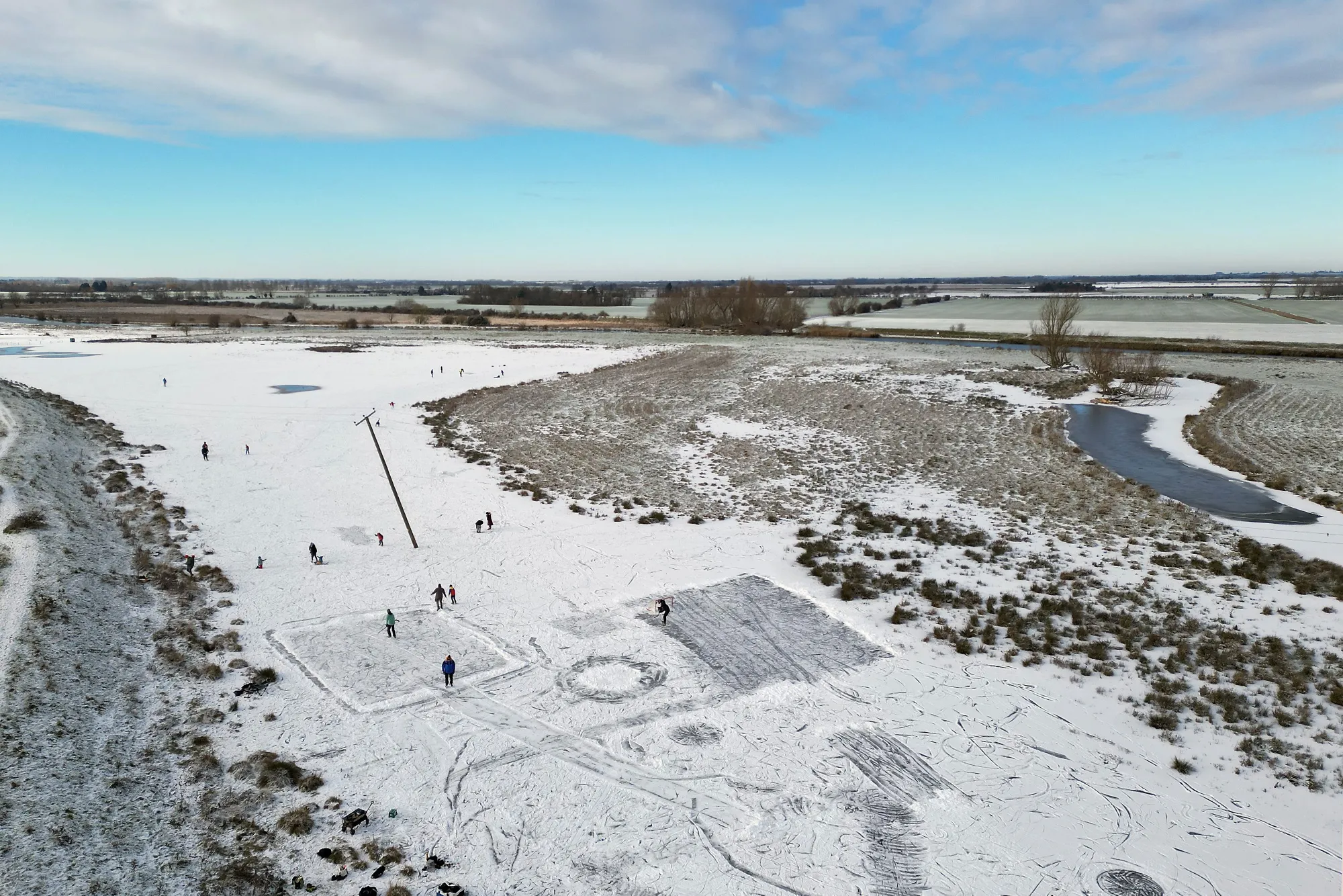 People play on a frozen flooded field in&nbsp;Cambridgeshire, UK.