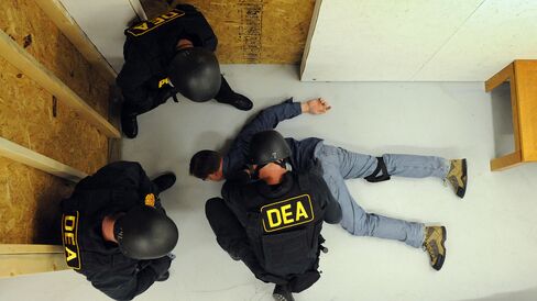 U.S. Drug Enforcement Administration (DEA) Agents simulate a raid in their Tactical Training Facility at the DEA Training Academy in Quantico, Virginia.