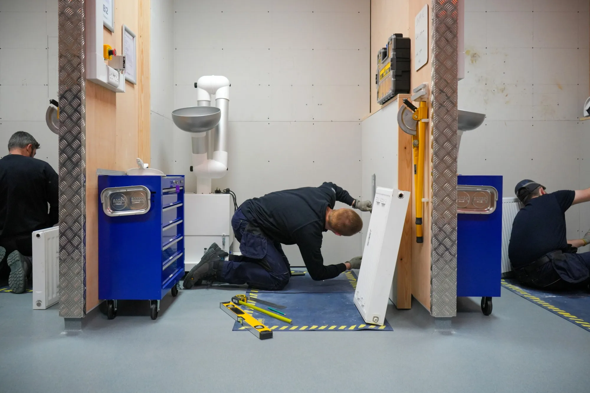 Octopus Energy apprentices during a training exercise installing radiators at the companys Sheffield Catalyst site within Sheffield Business Park.