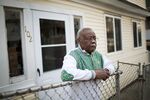 Hamson McPherson, 77, who was denied a home loan modification request by his bank after the foreclosure crisis, stands outside his house in 2011. 