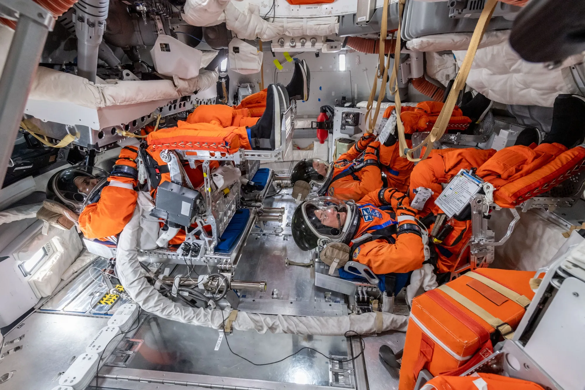 Crew members Reid Wiseman, Victor Glover, Christina Koch and Jeremy Hansen prepare at the Space Vehicle Mockup Facility.