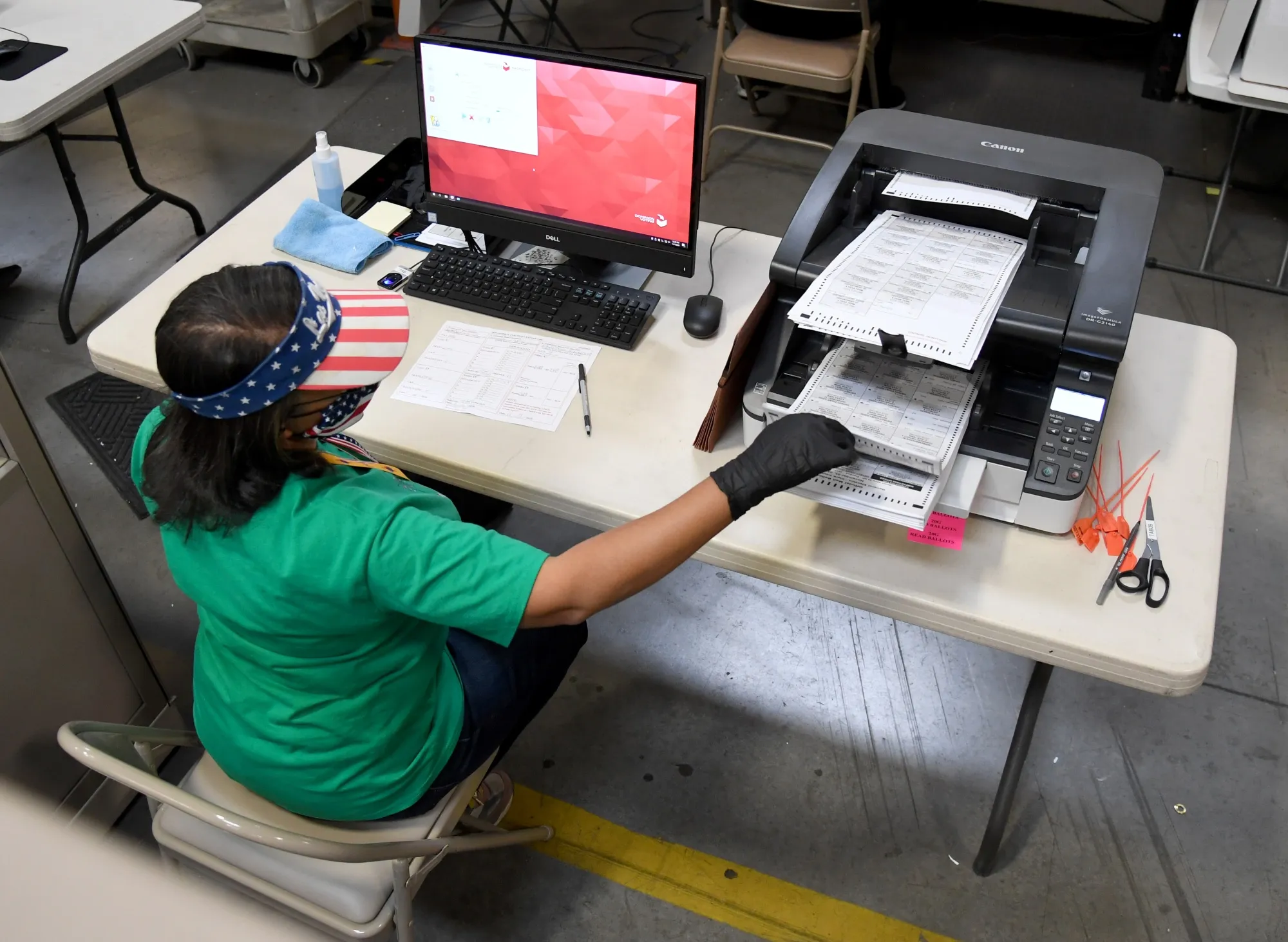 A Clark County election worker scans mail-in ballots at the Clark County Election Department on November 7, 2020 in North Las Vegas.