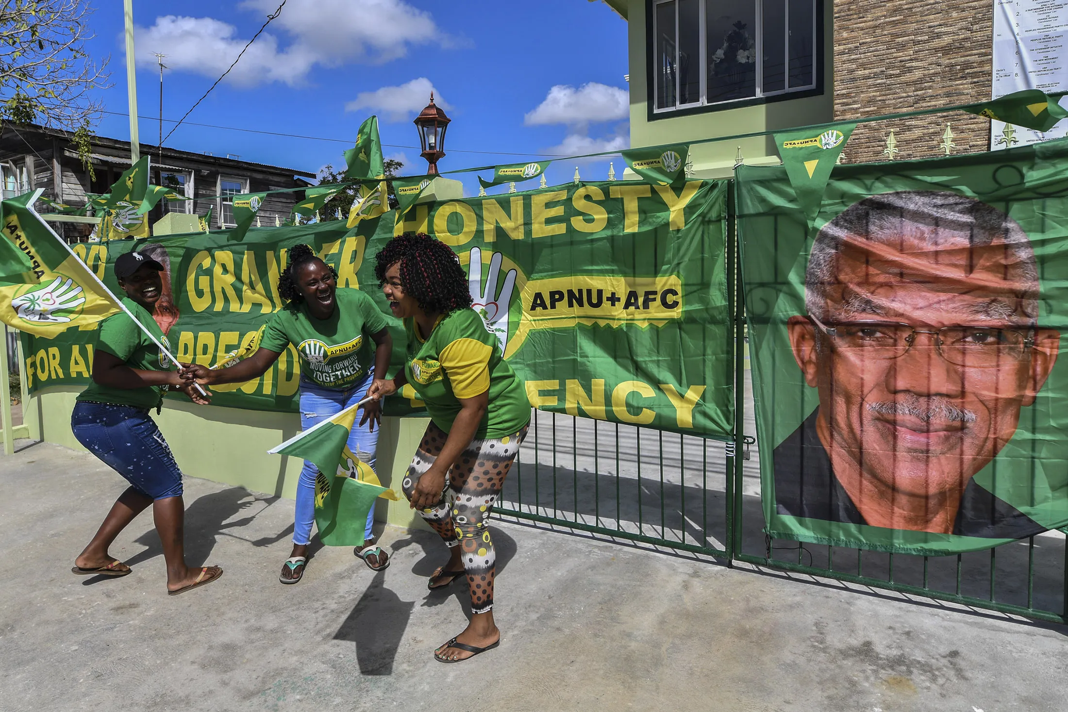Supporters of&nbsp;David Granger, of the National Unity and Alliance for Change (APNU+AFC) party, cheer and wave flags in Georgetown, Guyana, on March 1.