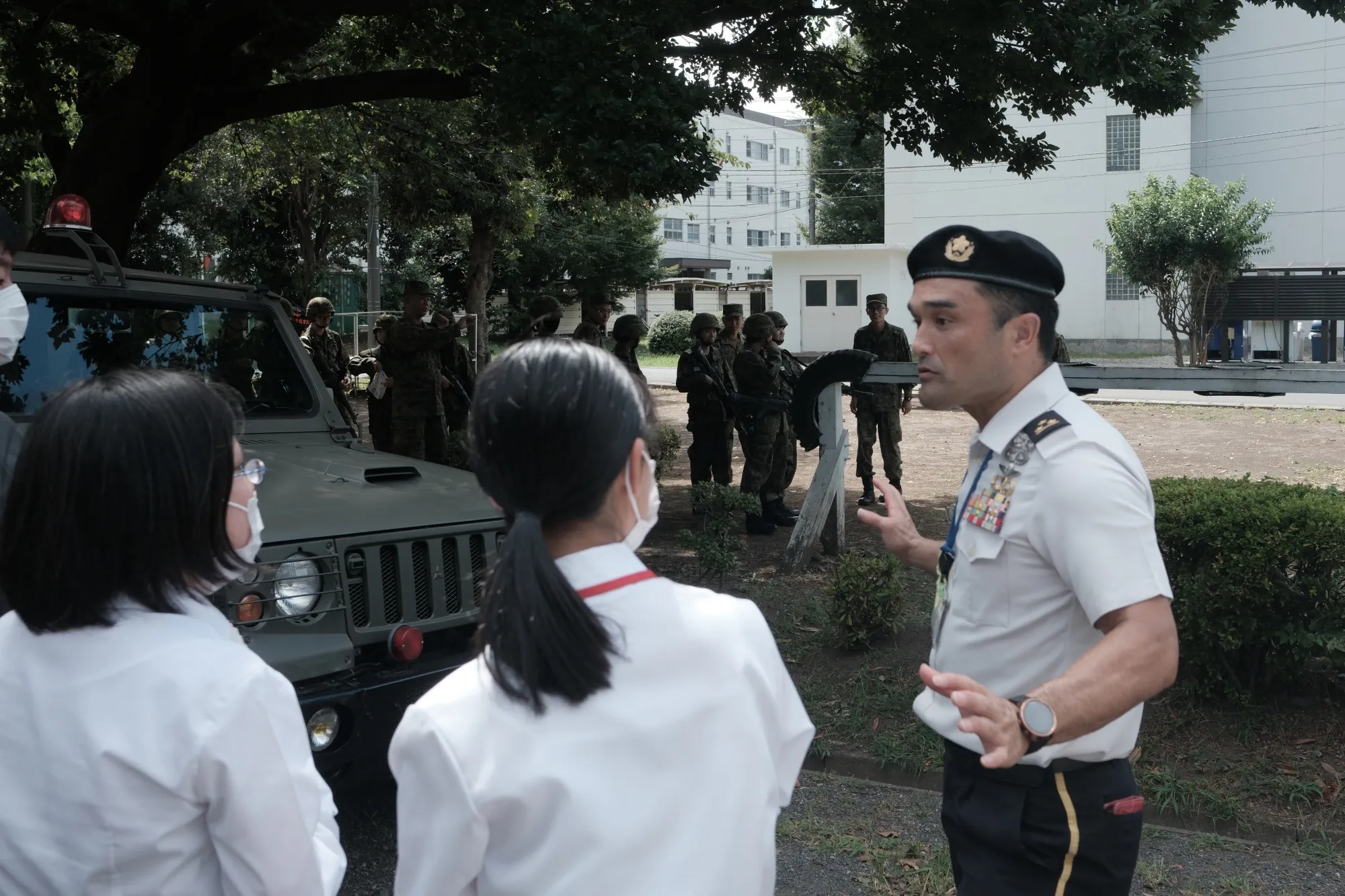 A Japan Self-Defense Forces member&nbsp;speaks to participants during an information session at Camp Nerima in Tokyo in August.