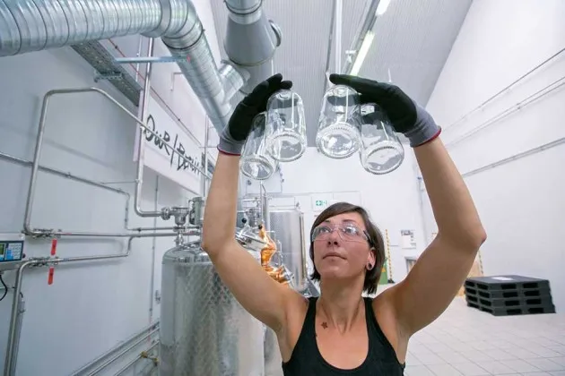 An Our/Berlin worker inspects bottles